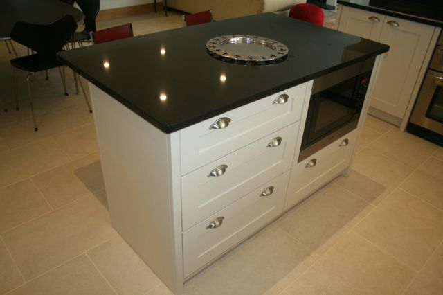 Graded drawer unit with built in microwave cooker in island unit